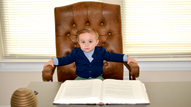 Your Business Has A Heart young boy sitting in a big leather chair in front of a business desk